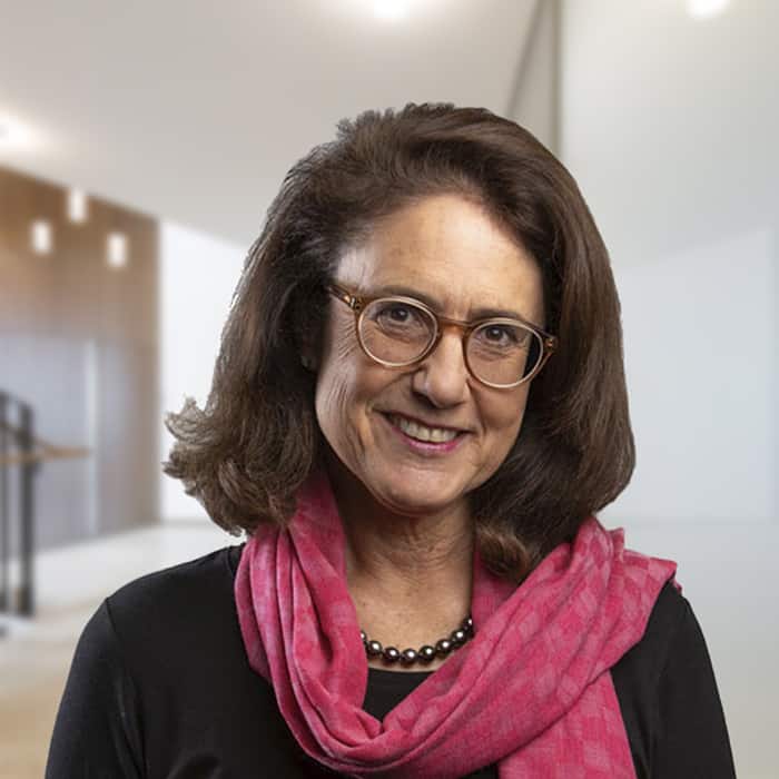 a woman wearing glasses and a pink scarf