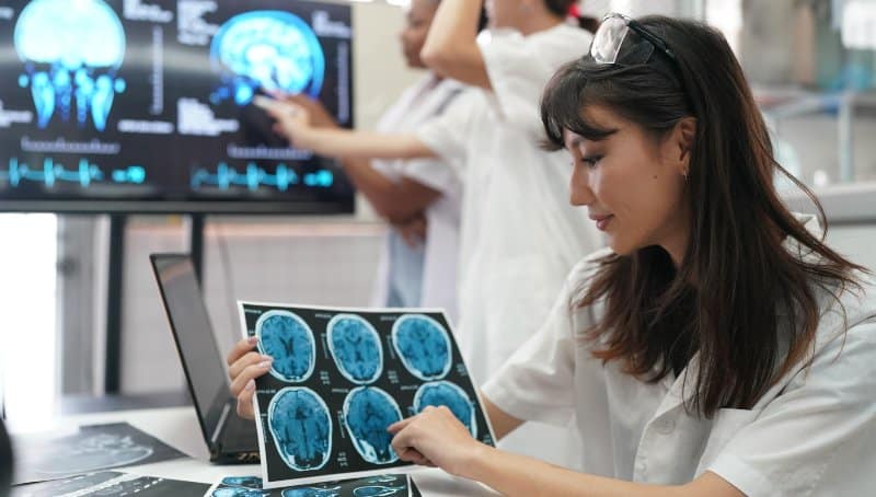 Healthcare worker examining a brain scan in a clinic